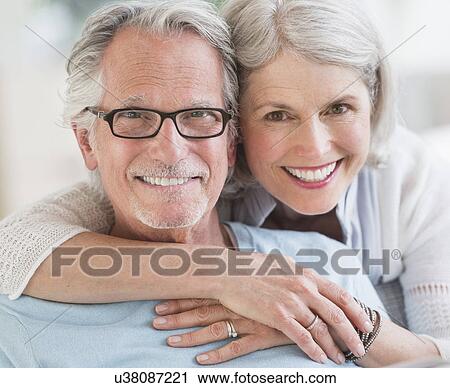 Stock Image - Senior woman embracing senior man. Fotosearch