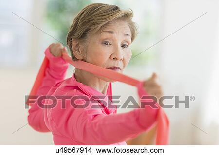 Senior woman exercising with exercise band View Large Photo Image Picture - Senior woman exercising with exercise band. Fotosearch