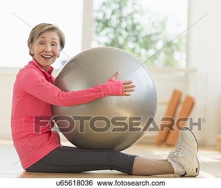 Senior woman exercising with fitness ball View Large Photo Image Stock Photograph - Senior woman exercising with fitness ball. Fotosearch