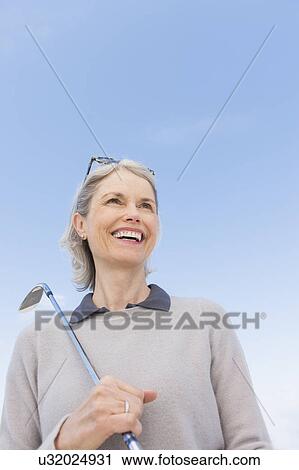 Senior woman holding golf club View Large Photo Image Stock Image - Senior woman holding golf club. Fotosearch