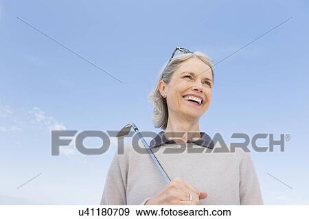 Senior woman holding golf club View Large Photo Image Stock Photo - Senior woman holding golf club. Fotosearch