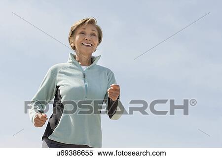 Stock Photography - Senior woman jogging. Fotosearch