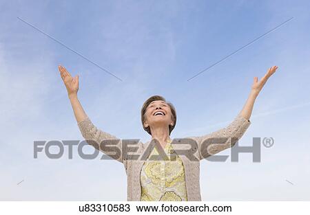 Senior woman looking up at blue sky View Large Photo Image Stock Image - Senior woman looking up at blue sky. Fotosearch