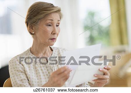 Senior woman reading letter View Large Photo Image Stock Photo - Senior woman reading letter. Fotosearch