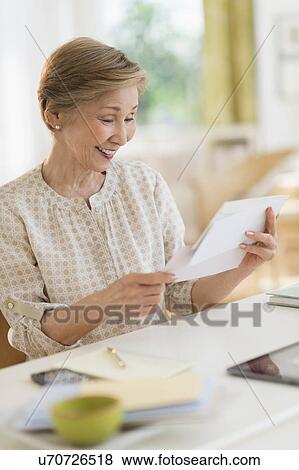 Senior woman reading letter View Large Photo Image Stock Photo - Senior woman reading letter. Fotosearch