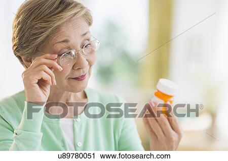 Senior woman reading medicine label View Large Photo Image Stock Image - Senior woman reading medicine label. Fotosearch