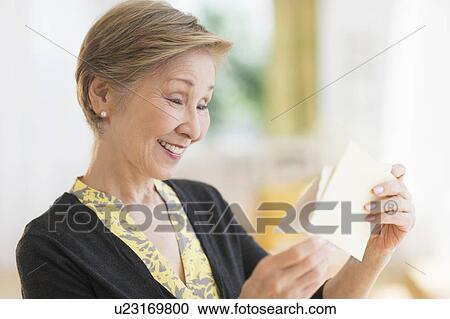 Senior woman reading note View Large Photo Image Stock Image - Senior woman reading note. Fotosearch