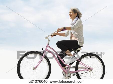 Senior woman riding bicycle View Large Photo Image Stock Image - Senior woman riding bicycle. Fotosearch