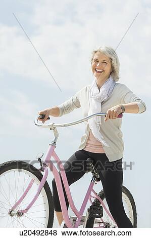 Senior woman riding bicycle View Large Photo Image Stock Photo - Senior woman riding bicycle. Fotosearch