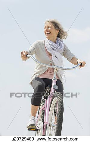 Senior woman riding bicycle View Large Photo Image Stock Photo - Senior woman riding bicycle. Fotosearch