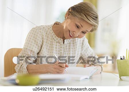 Senior woman writing in diary View Large Photo Image Stock Image - Senior woman writing in diary. Fotosearch