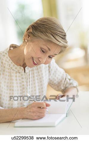 Senior woman writing in diary View Large Photo Image Stock Photo - Senior woman writing in diary. Fotosearch