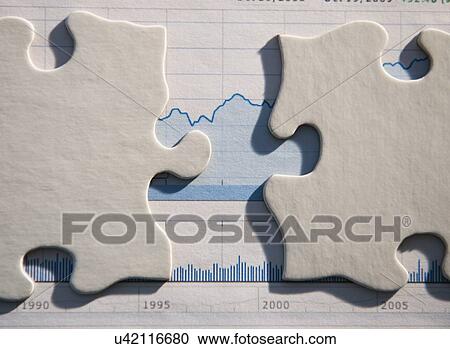 Stock Image - Studio Shot of financial graph and puzzle pieces. Fotosearch