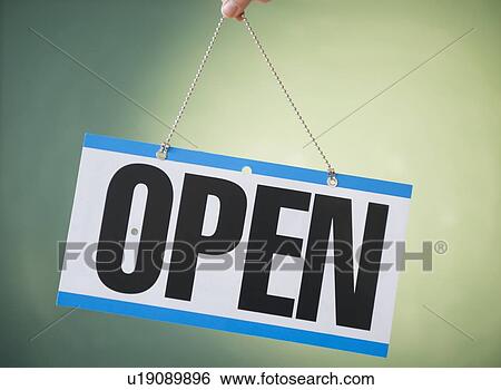 Studio Shot of human hand holding open sign View Large Photo Image Stock Photograph - Studio Shot of human hand holding open sign. Fotosearch