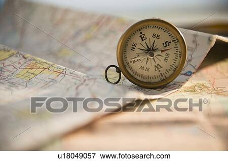 Stock Photo - Studio Shot of maps and compass. Fotosearch