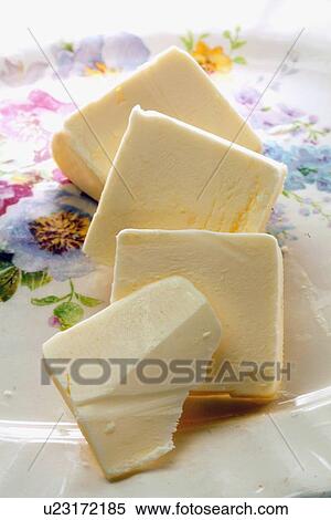 Stock Photography - Studio Shot of sliced butter. Fotosearch
