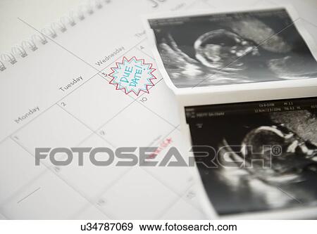 Studio Shot of ultrasound picture lying on calendar View Large Photo Image Stock Photo - Studio Shot of ultrasound picture lying on calendar. Fotosearch