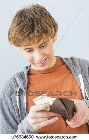 Teenage boy (14-15) counting money View Large Photo Image Stock Image - Teenage boy (14-15) counting money. Fotosearch