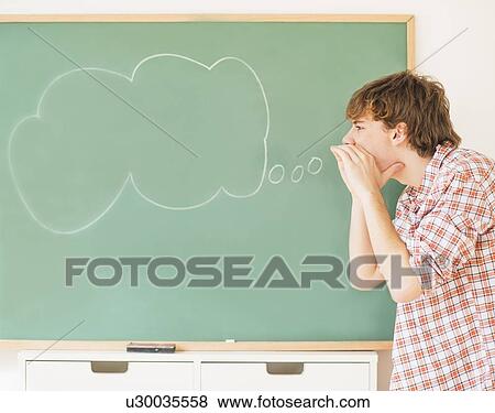Teenage boy (14-15) having fun in classroom View Large Photo Image Stock Photo - Teenage boy (14-15) having fun in classroom. Fotosearch