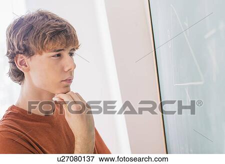 Teenage boy (14-15) in classroom View Large Photo Image Stock Photo - Teenage boy (14-15) in classroom. Fotosearch