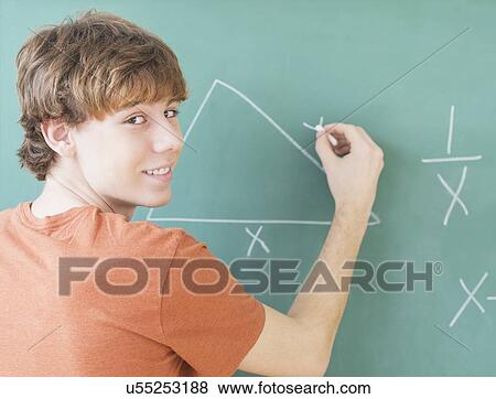 Stock Photo - Teenage boy (14-15) in classroom. Fotosearch