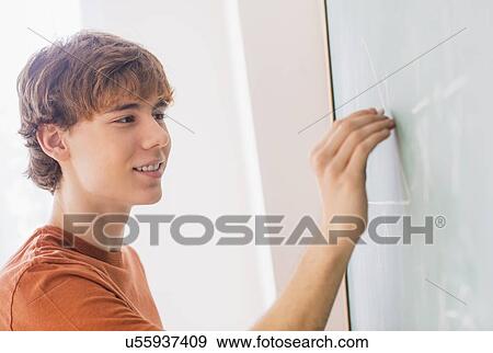 Teenage boy (14-15) in classroom View Large Photo Image Stock Photo - Teenage boy (14-15) in classroom. Fotosearch
