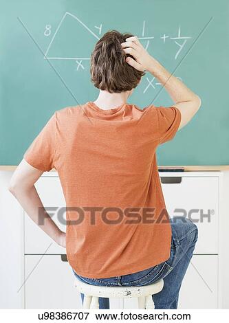Stock Photo - Teenage boy (14-15) in classroom. Fotosearch