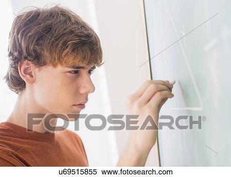 Stock Photography - Teenage boy (14-15) in classroom. Fotosearch