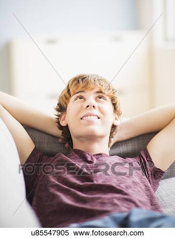 Teenage boy (14-15) laying down and looking up View Large Photo Image Stock Photography - Teenage boy (14-15) laying down and looking up. Fotosearch