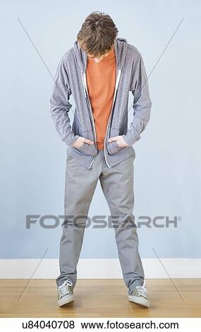 Teenage boy (14-15) looking down View Large Photo Image Stock Photo - Teenage boy (14-15) looking down. Fotosearch