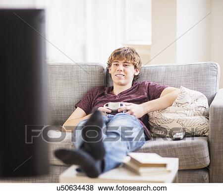 Teenage boy (14-15) playing video game View Large Photo Image Stock Photo - Teenage boy (14-15) playing video game. Fotosearch