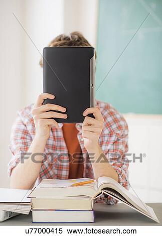 Teenage boy (14-15) sitting in classroom with tablet pc View Large Photo Image Stock Photography - Teenage boy (14-15) sitting in classroom with tablet pc. Fotosearch