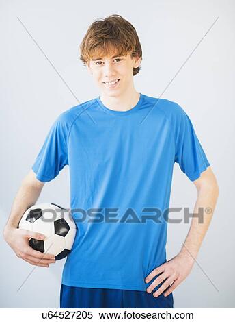 Stock Photography - Teenage boy (14-15) with ball. Fotosearch