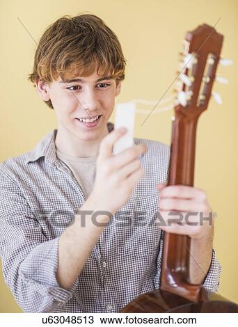 Teenage boy (14-15) with guitar View Large Photo Image Stock Image - Teenage boy (14-15) with guitar. Fotosearch