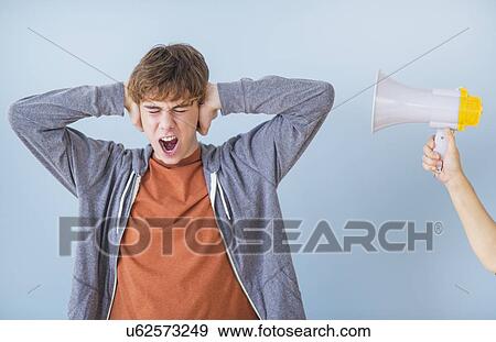 Teenage boy (14-15) with hands on ears View Large Photo Image Stock Photo - Teenage boy (14-15) with hands on ears. Fotosearch