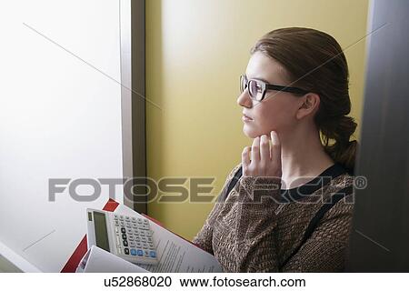 Woman doing paperwork View Large Photo Image Stock Image - Woman doing paperwork. Fotosearch