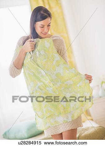 Stock Photography - Woman holding dress. Fotosearch