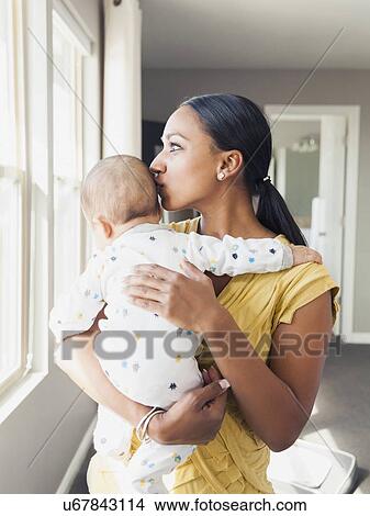 Woman holding her baby son (2-5 months) View Large Photo Image Picture - Woman holding her baby son (2-5 months). Fotosearch