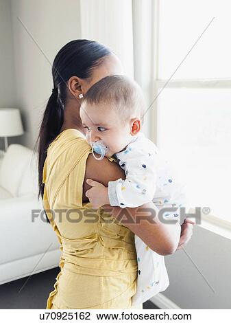 Woman holding her baby son (2-5 months) View Large Photo Image Stock Image - Woman holding her baby son (2-5 months). Fotosearch