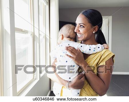 Woman holding her baby son (2-5 months) View Large Photo Image Stock Photograph - Woman holding her baby son (2-5 months). Fotosearch