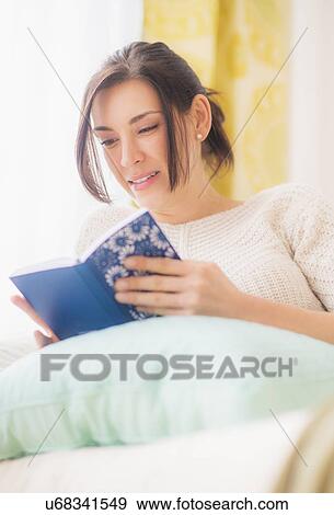 Woman leaning against pillow in bed and reading book View Large Photo Image Stock Photo - Woman leaning against pillow in bed and reading book. Fotosearch