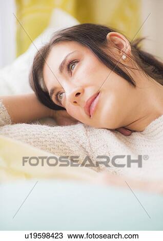 Woman lying on bed with hand behind head View Large Photo Image Stock Image - Woman lying on bed with hand behind head. Fotosearch