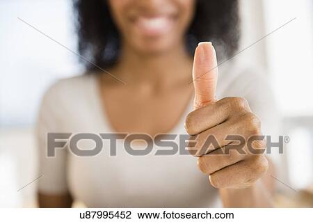 Woman making thumbs up gesture View Large Photo Image Stock Image - Woman making thumbs up gesture. Fotosearch