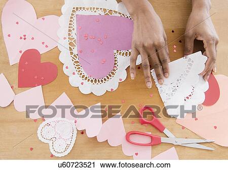 Stock Image - Woman making Valentine decoration. Fotosearch