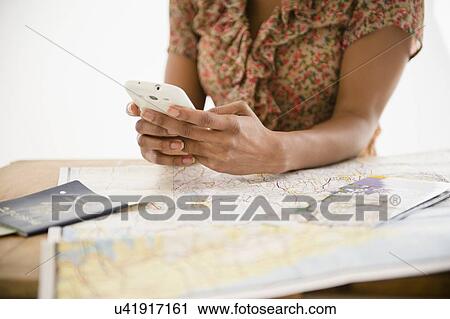Stock Image - Woman planning trip. Fotosearch