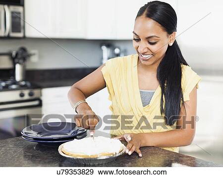 Woman preparing meal in kitchen View Large Photo Image Stock Photo - Woman preparing meal in kitchen. Fotosearch