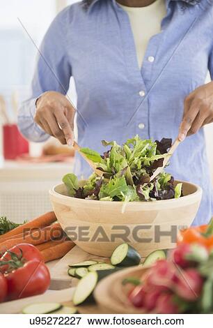 Stock Photo - Woman preparing salad. Fotosearch