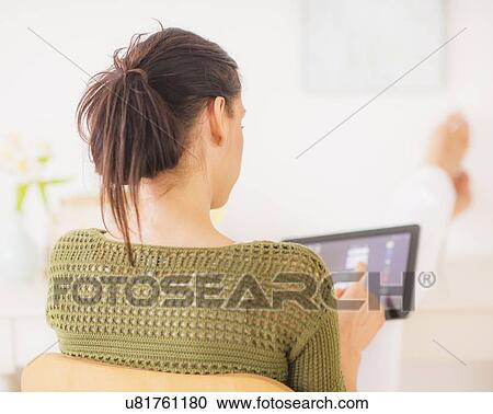 Stock Image - Woman using tablet pc. Fotosearch