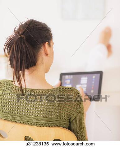 Woman using tablet pc View Large Photo Image Stock Photography - Woman using tablet pc. Fotosearch