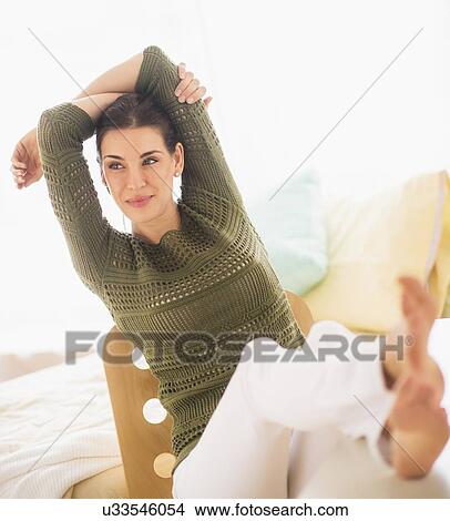 Woman with feet up and hands behind head View Large Photo Image Picture - Woman with feet up and hands behind head. Fotosearch